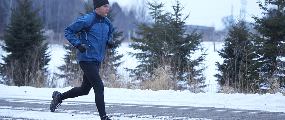 Athletic man running in winter.